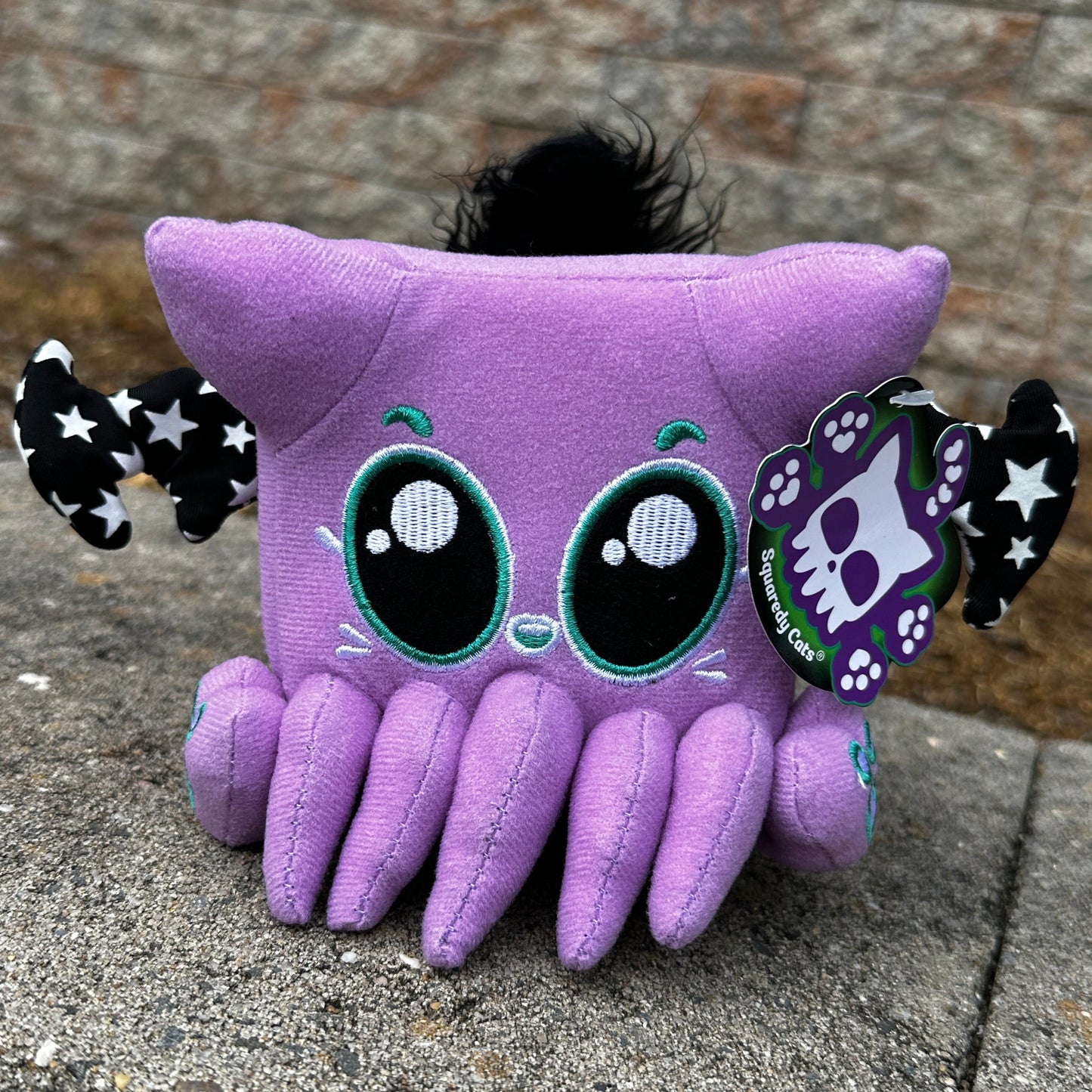 purple plush with tentacles glows green